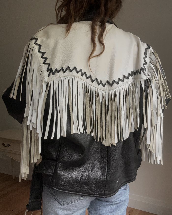Back of a vintage black and white leather fringe jacket